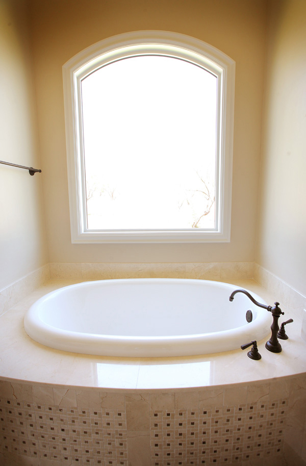 Bathroom Design (Custom Texas Homes): Rohl Faucet and Bow Front Tub with Marble Tile