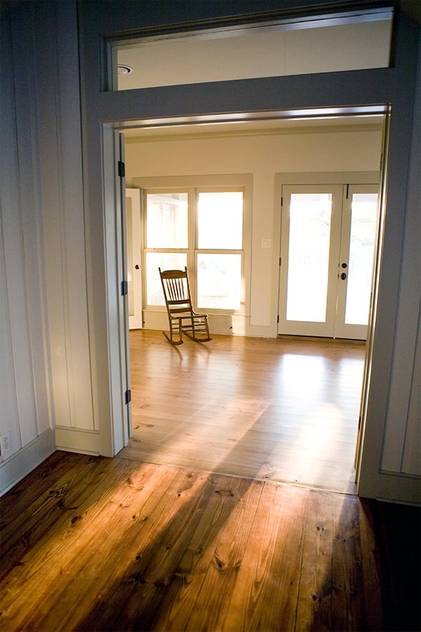 Living Room Design (Texas Homes): rocking chair in music room with stained pine floors