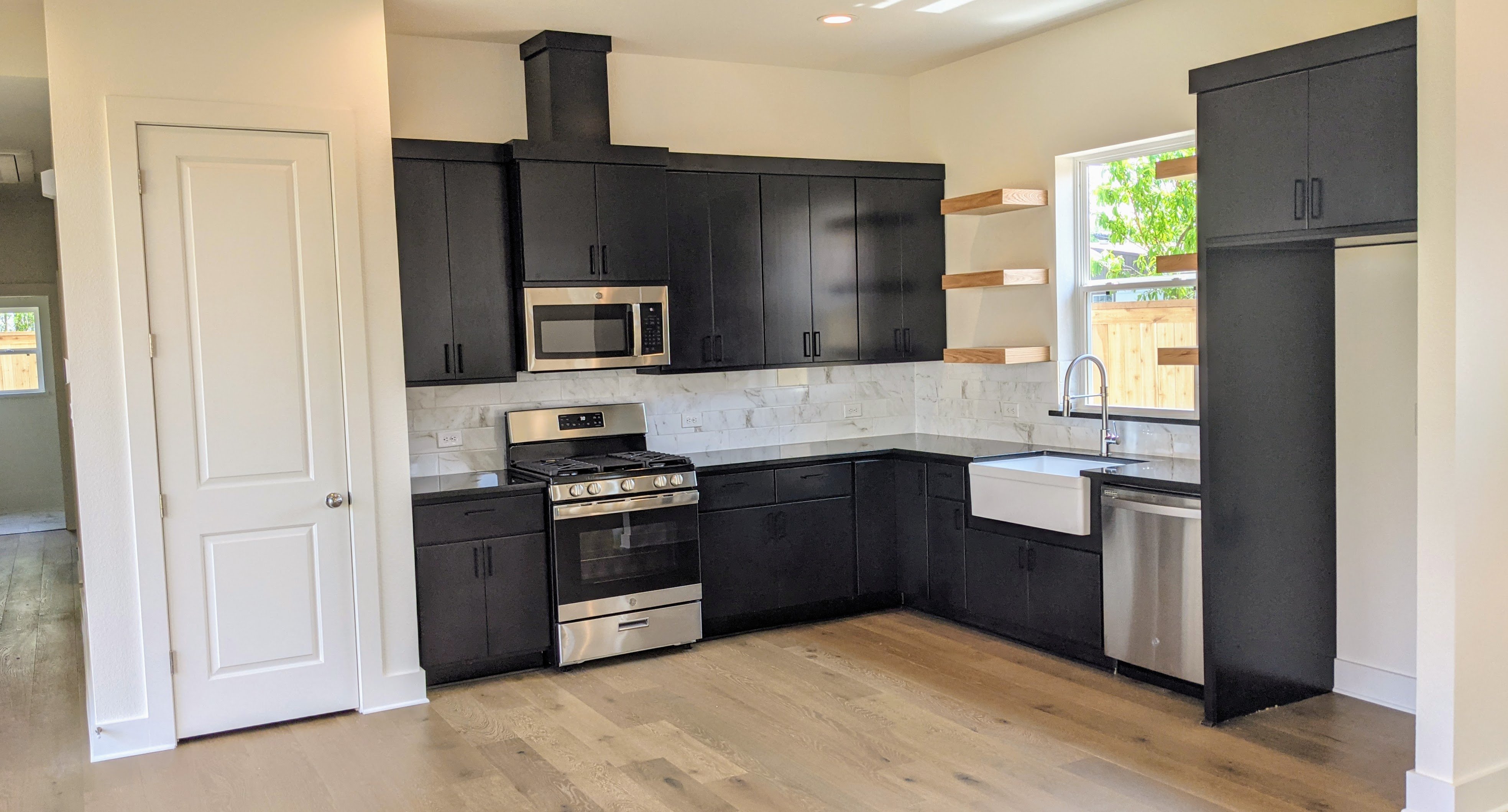 modern kitchen with floating shelves dark cabinets