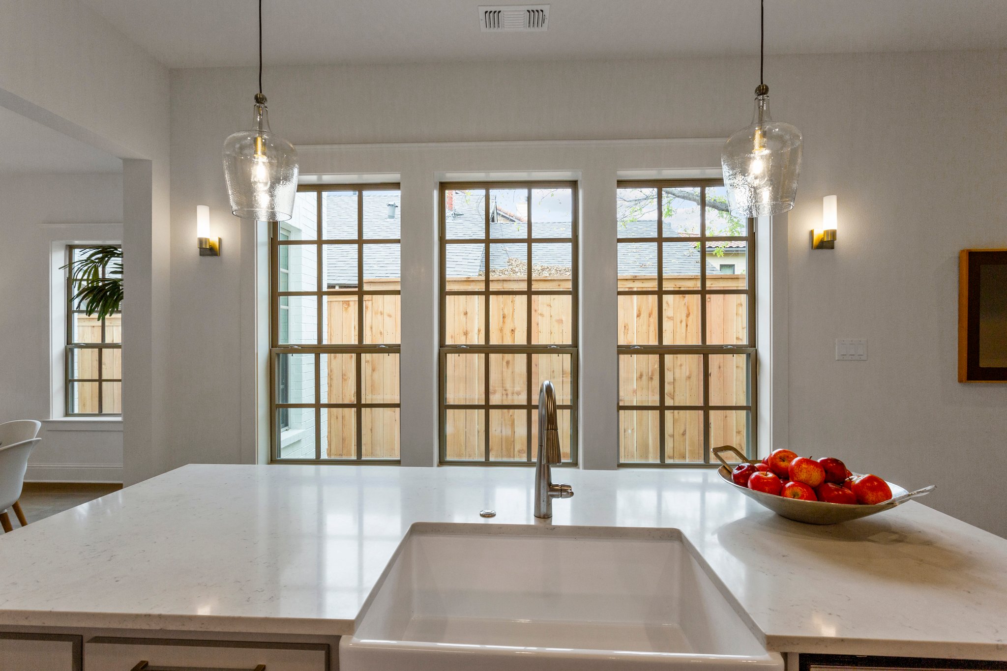 windows with bowl of fruit on island