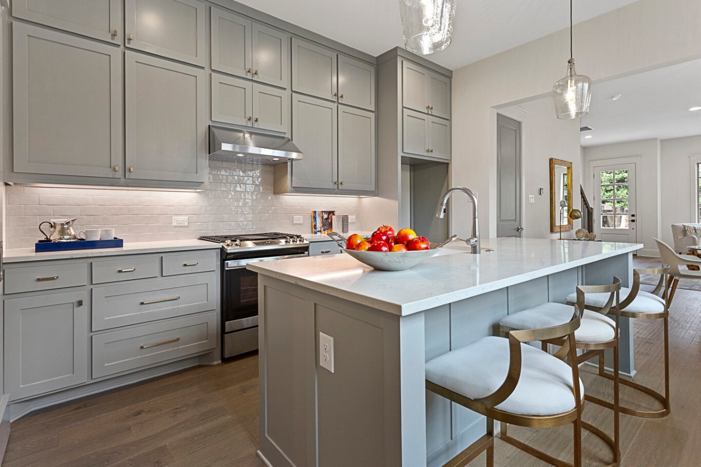 Townhome kitchen view to island brass chairs